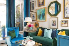 a colorful maximalist living room with double height ceilings, a neutral floor with a printed rug, blue and green furniture, a bold gallery wall