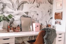a fancy and glam home office with a floral wallpaper wall, a white desk, a leather chair, a pink neon light and a mirror