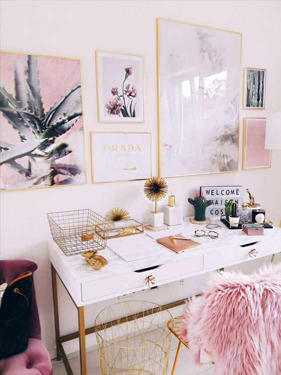 a fancy and glam home office with a white desk, a gold chair with pink faux fur, a lovely glam gallery wall in gold frames