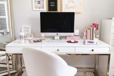 a fancy home office wiht neutral walls, a white and gold desk, a white chair, a chic gallery wall and a floor mirror is amazing