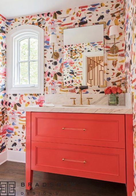 a maximalist bathroom with colorful watercolor walls, a red vanity, gold touches is a veyr refined, bright and chic idea