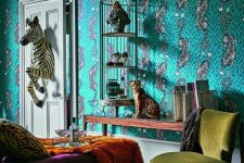 a maximalist living room with catchy green wallpaper, a cage with art and shoes, a leopard figurine and a zebra coming through the door, jewel tone furniture