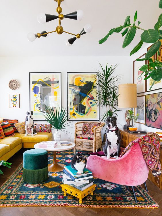 a maximalist living room with colorful furniture, rattan chairs, bright rugs, pillows and books and colorful gallery walls