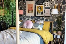 a mid-century modern maximalist bedroom with a floral accent wall, a wooden bed with a stand for hanging plants and a striped stool