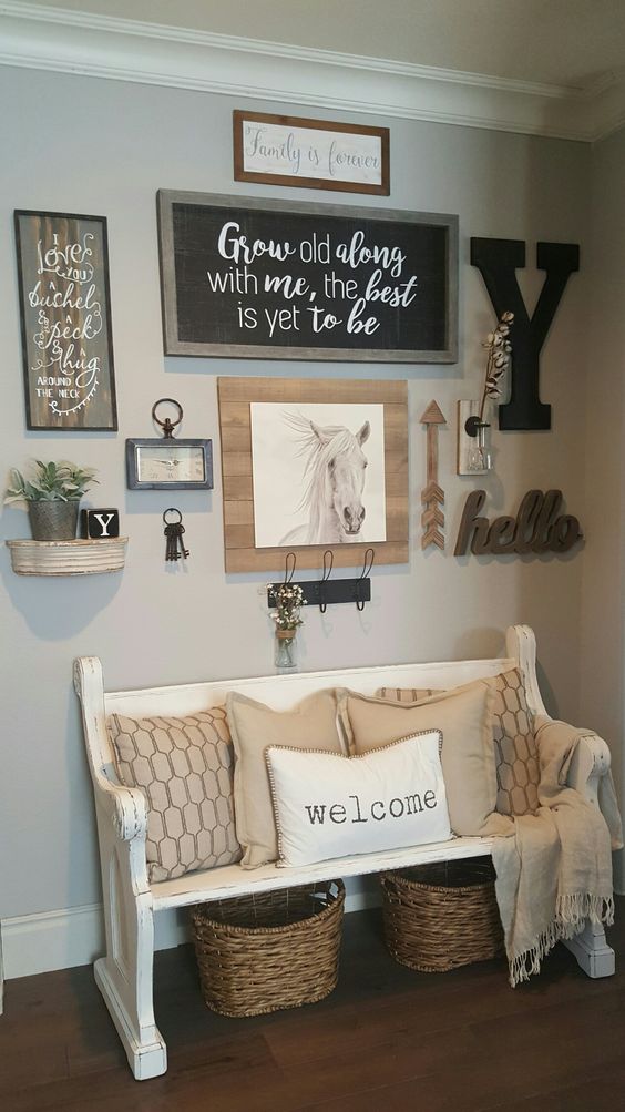 a rustic gallery wall with a chalkboard sign in a frame, artworks, monograms, arrows, a clock and various potted plants