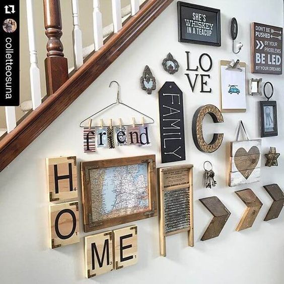 a rustic gallery wall with wooden plaques, monogrames, signs in frames and a map is a cute and lovely idea