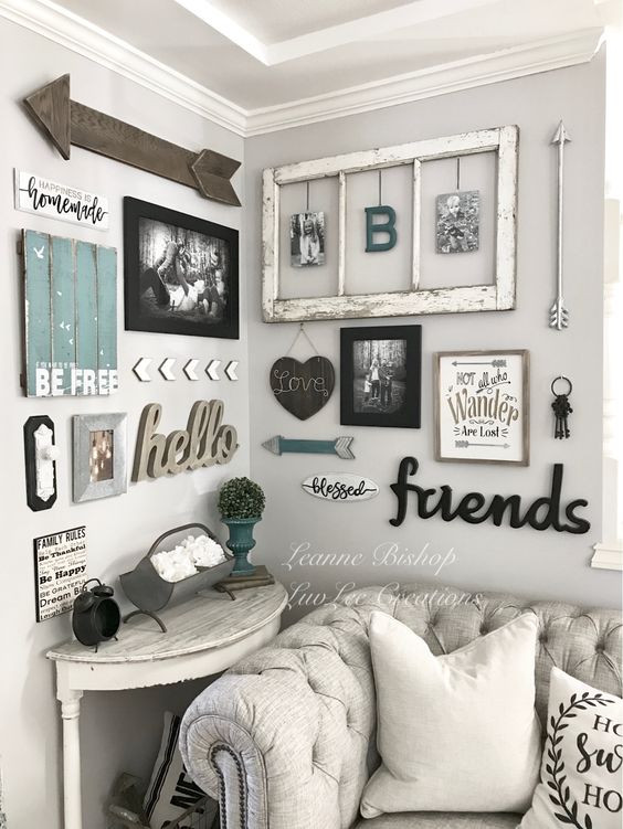 a shabby chic rustic gallery wall with a window frame, calligraphy, photos in frames, arrows and signs is cool