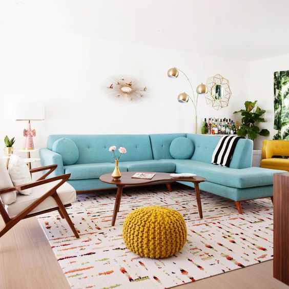 a welcoming mid-century modern living room with a turquoise sofa, elegant mid-century modern furniture and touches of gold for chic