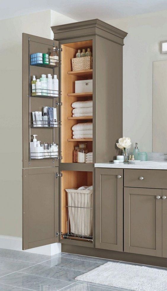 a stylish and chic farmhouse bathroom done with taupe kitchen cabinets for storage and a vanity formed of them, too