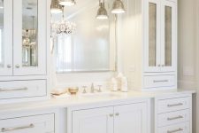 17 an elegant and stylish creamy bathroom made with vintage kitchen cabinets, a mirror in a metallic frame and vintage pendant lamps
