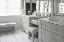 20 a beautiful dove grey bathroom done with kitchen cabinets, large mirrors, a bench and a stool and sconces