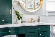 21 a bright and chic bathroom with dark green kitchen cabinetry, a penny tile floor, some gold touches for more chic
