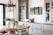 34 a beautiful farmhouse dining room done with grey kitchen cabinets, a wooden dining set and a wooden bead chandelier