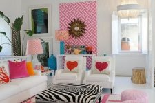 a bright and fun living room with white furniture, hot pink stools and pale pink poufs, a bold artwork and bold printed pillows