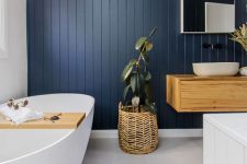 a bathroom with a navy wall looks chic