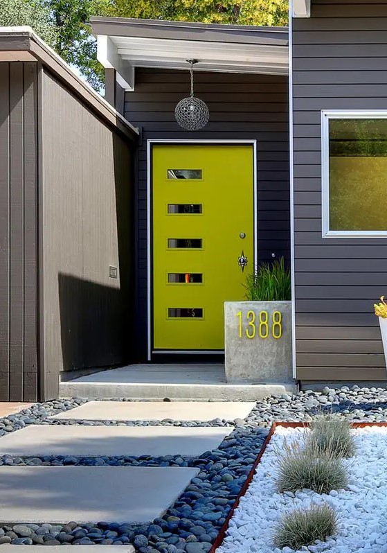 A mid century modern neon green front door with glass pants and a concrete planter with a neon green house number for a modern home