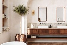 a modern country bathroom with white walls and a ceiling, a stained chevron floor, a stained vanity and arched niches is lovely