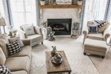 a modern country living room with a fireplace, elegant neutral furniture, printed textiles and a low coffee table is amazing