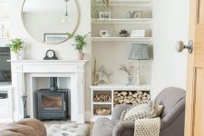 a modern country living room with a hearth, a grey sofa and an ottoman, a leather sofa, firewood, built-in shelves and potted plants