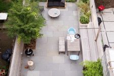 a sunken patio with growing and potted plants, with a living and dining space is very welcoming and stylish