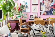 an eclectic space with a hot pink accent wall and a gallery wall, quirky and mismatching furniture, lots of potted plants and blooms and printed pillows