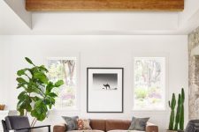 a spacious living room with exposed wooden beams