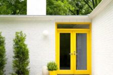 yellow glass front doors plus a yellow planter with greenery is a gorgeous idea to make the entrance of a modern house bold and cool