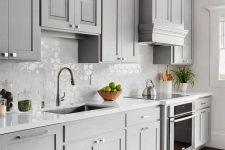 10 a beautiful dove grey modern farmhouse kitchen with a white Moroccan tile backsplash and white stone countertops plus neutral fixtures