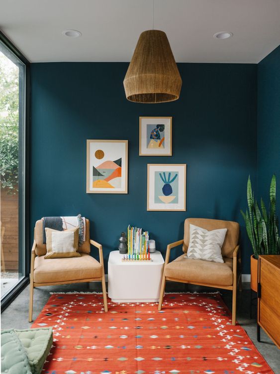 cool mid-century modern chairs and a coffee table, a bright gallery wall and printed textiles are lovely for a millennial living room