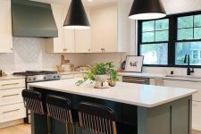 23 a chic modern kitchen with white and grey cabinets, a white chevron tile backsplash, black stools and black pendant lamps