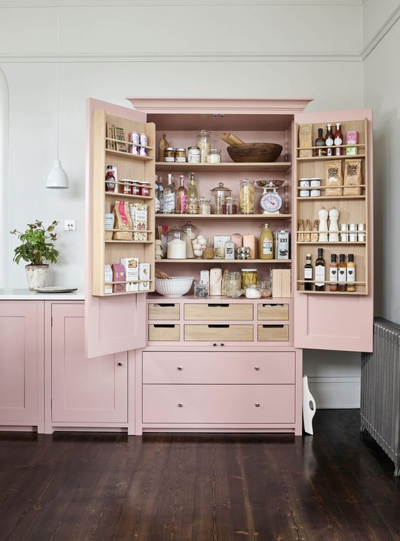 a pink mini pantry built into the kitchen is a lovely idea to store a lot of things and organize them at your best