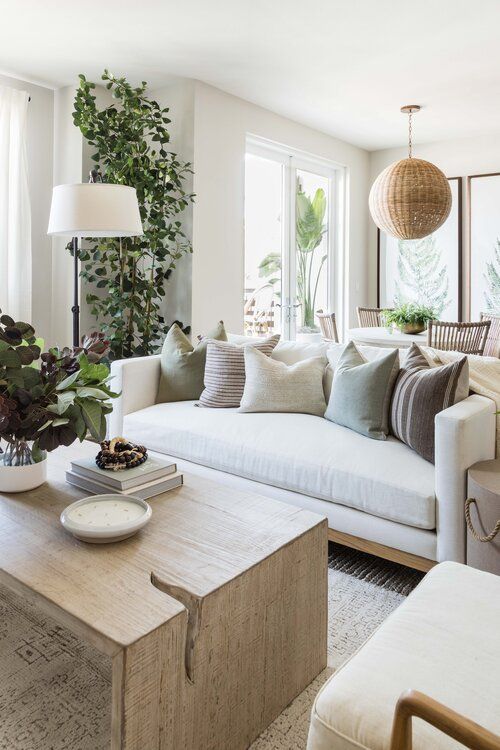 a neutral and chic living room and dining space dotted with amazing potted greenery and trees items is a very fresh idea