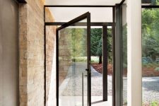 a black framed pivot front door gives a very stylish and ultra-modern feel to the space and makes it wow, bold and cool
