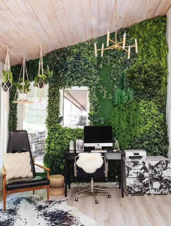 a bold home office with a faux living wall with much texture, suspended pots with plants, black and white furniture is a cool space