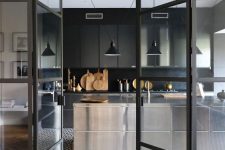 a moody dark kitchen design behind glass doors