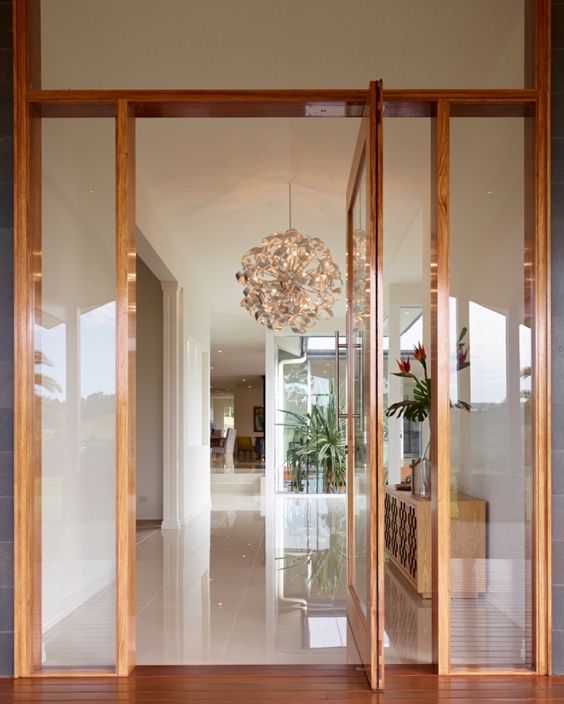 a delicate rich-stained and glass pivot entrance door will create a subtle and lightweight look at the entrance and will welcome