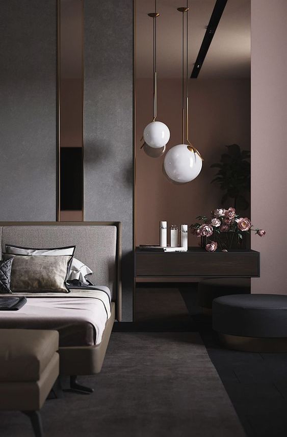 a dreamy contemporary bedroom with an accent wall done with dark mirrors, a chic bed, a leather ottoman, a floating nightstand and a round ottoman