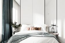 a light-filled contemporary bedroom with tall mirrors, floating nightstands, a bed with neutral bedding and green curtains is pure chic