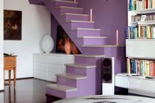 a lilac accent wall paired with a matching staircase gives a lovely touch of color and a unique decor feature to the space