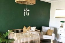 a stylish modern nursery design with a bold accent wall