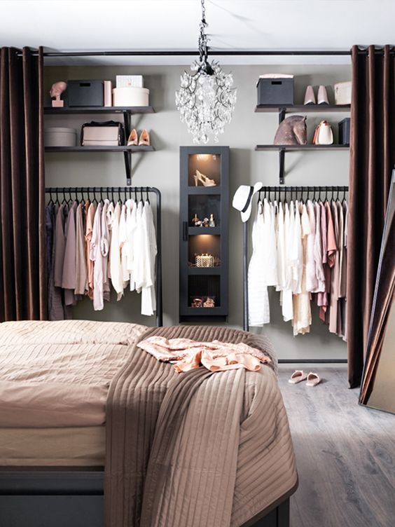 a stylish warm-colored modern bedroom with a large organized closet with chocolate brown curtains is a practical idea