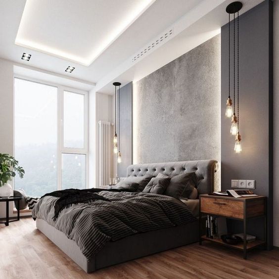 a terrific contemporary bedroom with a lit up ceiling, a grey upholstered bed, black panels on the wall, pendant lamps and a cool view