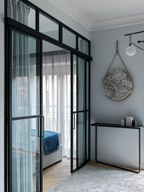 beautiful modern black French sliding doors will let a lot of light in and out and will subtly separate the spaces