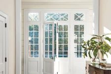 such white French doors with panes are wonderful for any space and perfectly fit this modern and elegant room