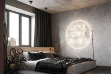 14 a contemporary industrial bedroom with a bed on a platform, black and white bedding, a neon sign, dark curtains and concrete walls and a ceiling