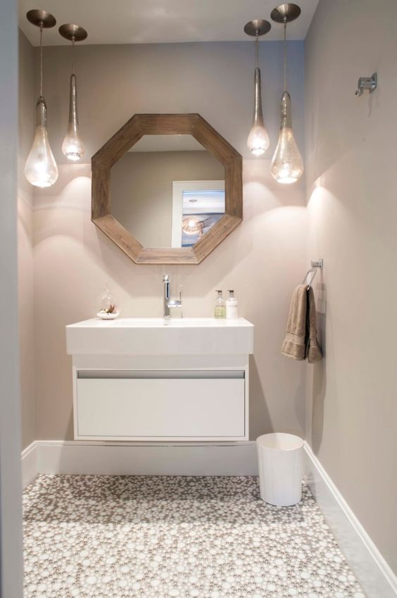a modern powder room with a floating vanity