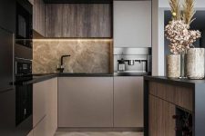a sophisticated taupe contemporary kitchen with dark stained and taupe cabinets, grey marble and black fixtures plus black built-in appliances