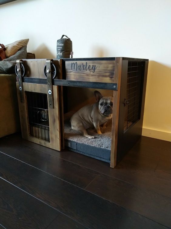a stained wood and blackened metal dog crate with a sliding door is a cool solution for an industrial or rustic space
