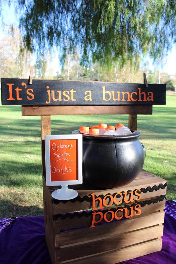 a cauldron filled with drink bottles is a cool idea for a kids' Halloween party, it can be also used to serve sweets