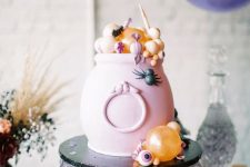 07 a pink cauldron with candies and sweets in pastel colors is a great way to serve some food in a truly Halloween way